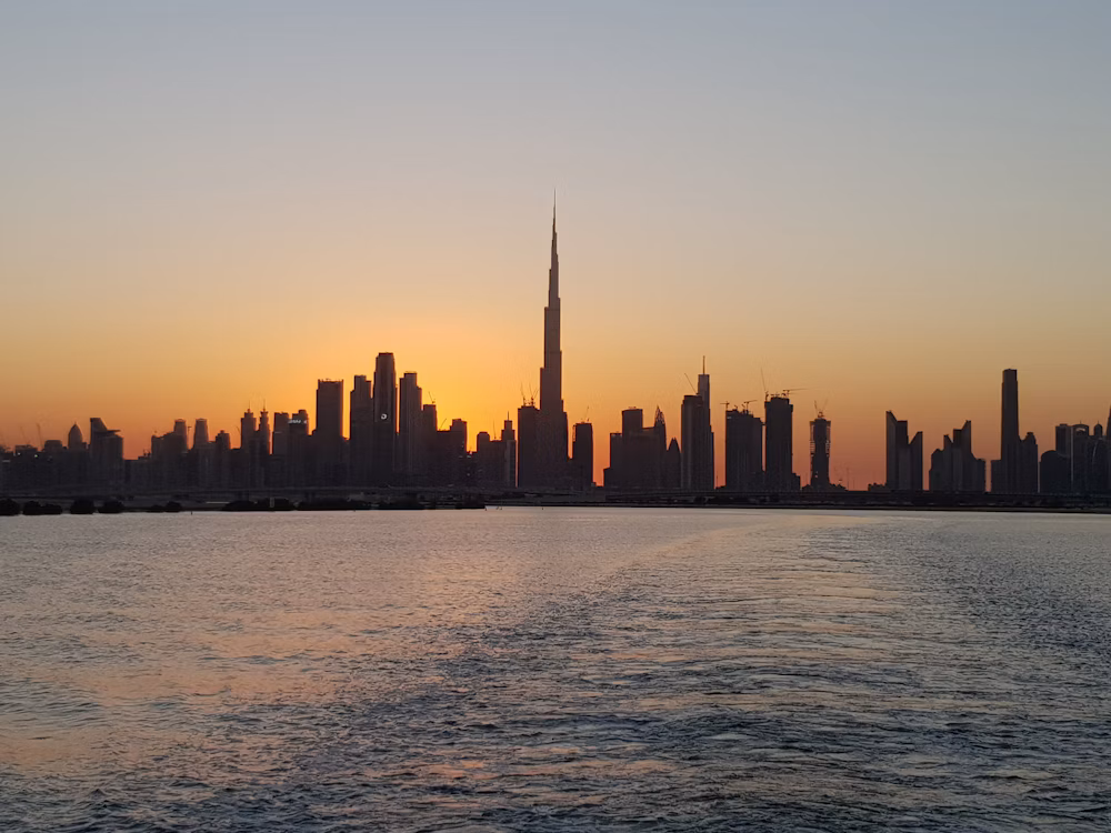 Dubai skyline across the waterfront at sunset