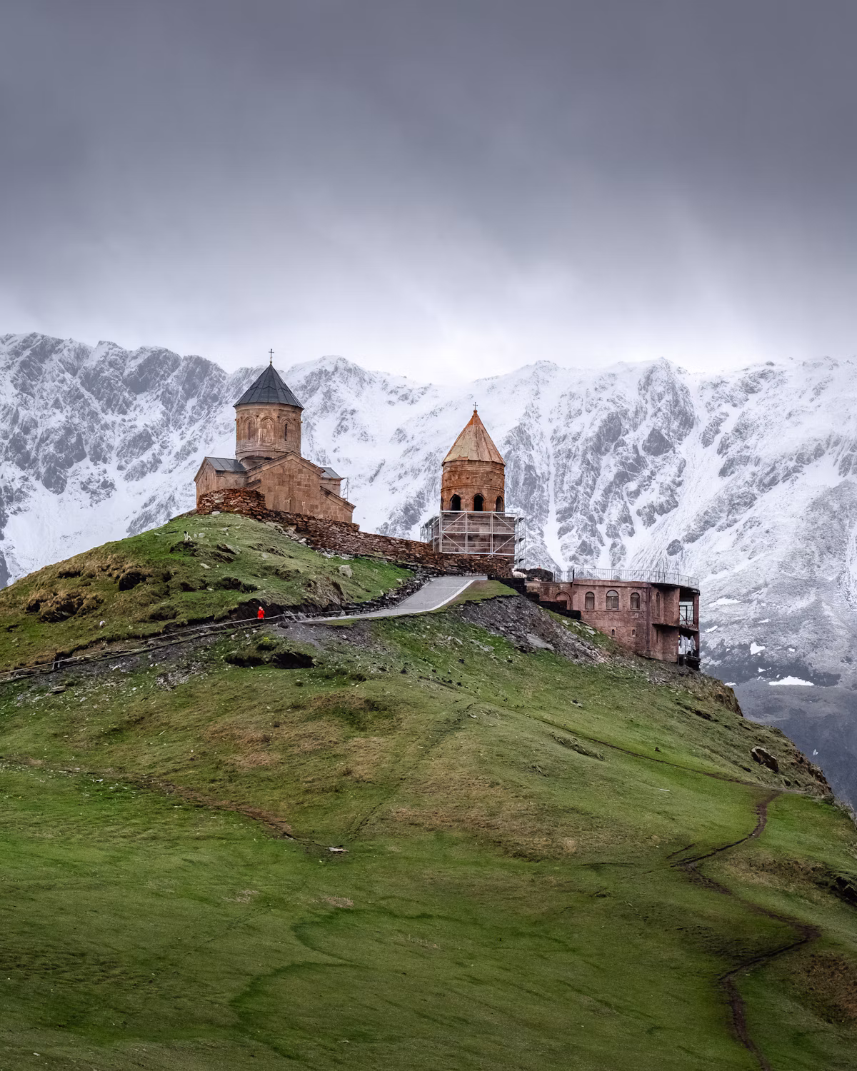 Gergeti Trinity Church in Georgia with the snowy Caucasus Mountains behind it